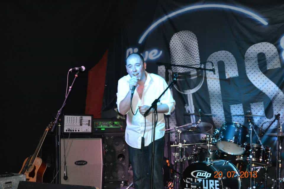 Diverse musician performing live on stage at Musibiz event.